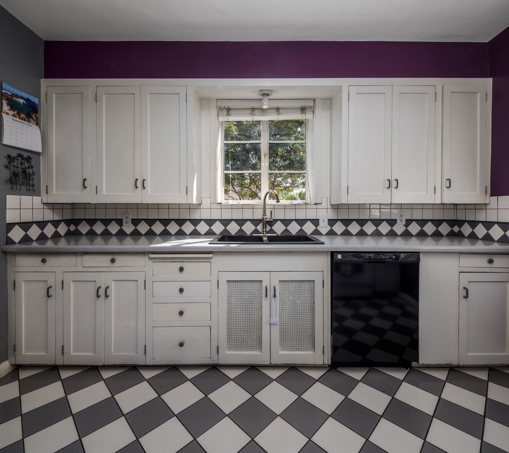 Checkerboard tile kitchen with original cabinets in Monterey Revival home in Phoenix Willo Historic District