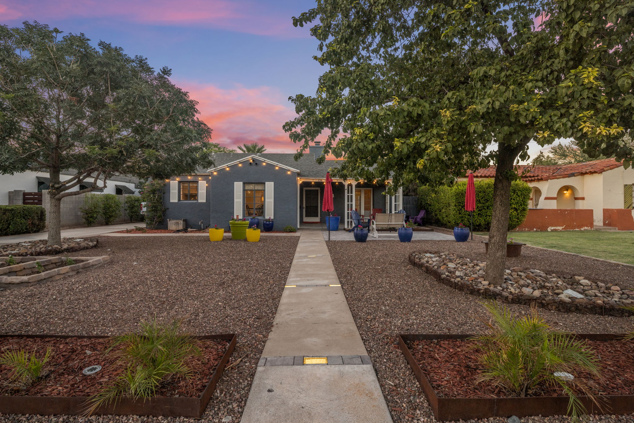 Front view of Monterey Revival home in Phoenix Willo Historic District with landscaped yard and covered porch